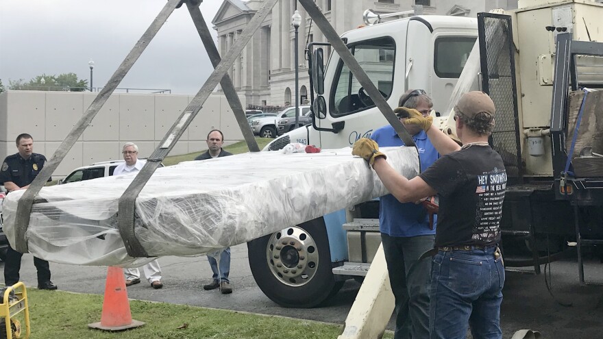 Workers used a crane to install a Ten Commandments monument Thursday outside the Arkansas state Capitol in Little Rock.