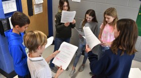 Children read in a group.