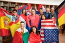 International multiethnic exchange of students, happy students presenting their countries with flags