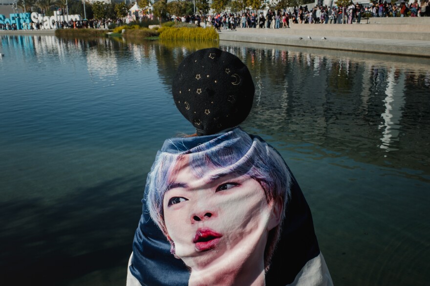 Tiffany Lui stands with a blanket of BTS member Jin before the concert. Lui spent her time handing out little BTS gift packs to other fans before the concert.