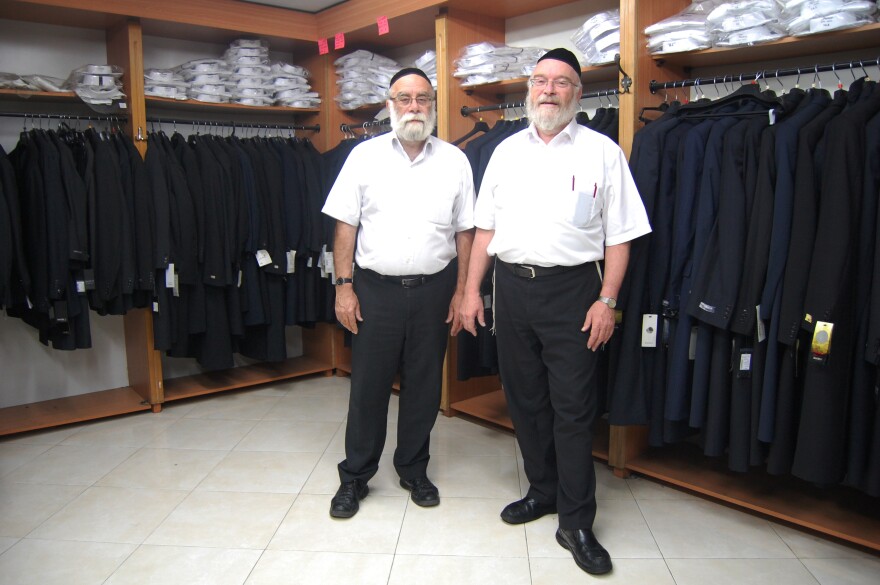 Yechiel Rubin, at left, and his brother Simcha run a men's clothing shop catering to ultra-Orthodox Jews in Jerusalem. They advise short linings and 100 percent wool as the coolest coat for the summer.