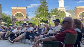 People sitting in camping chairs in plaza