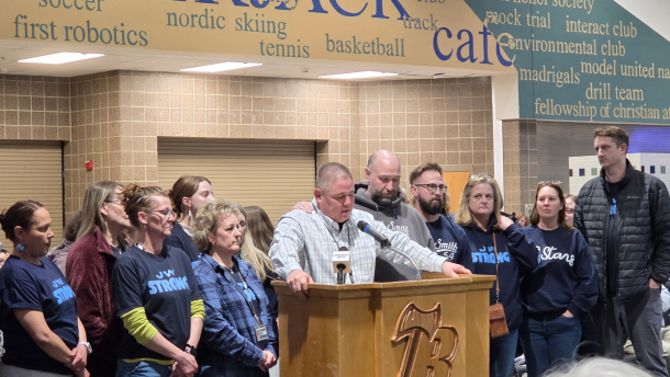 J.W. Smith Elementary Principal Bruce Goodwin addresses the Bemidji School Board, surrounded by J.W. staff, during a public hearing at Bemidji High School on March 24, 2026.