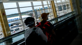 Travelers walk through Ronald Reagan Washington National Airport in Arlington, Virginia, on July 2, 2022. - US airlines are bracing customers for what will probably be a bumpy Fourth of July holiday weekend as the industry struggles to manage a surge in travel demand that probably exceeds its current capacity. Flight delays and cancellations created a difficult start for many travelers leaving town for the holiday. (Stefani Reynolds/AFP via Getty Images)