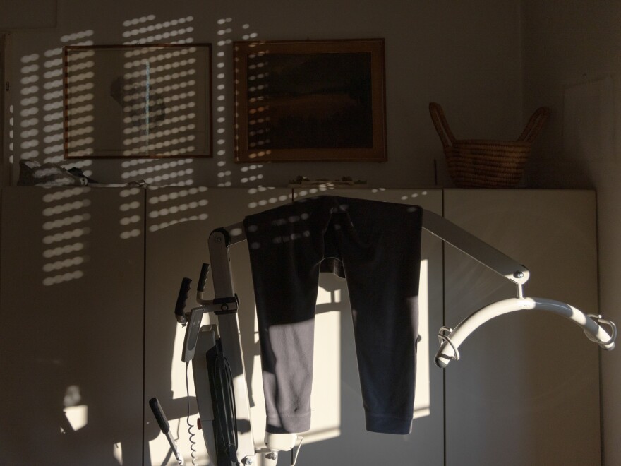 Clothing hangs on a mechanical lifter in Anna's home in Milan in December 2022.