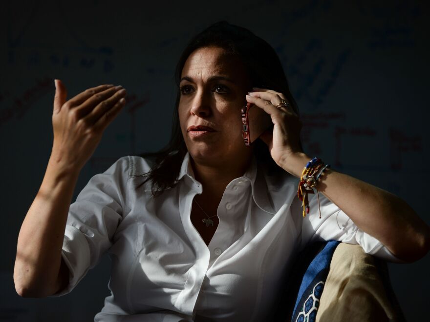 Venezuelan opposition politician María Corina Machado speaks on her mobile phone before an interview with the AFP in Caracas in August 2017.