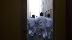 Detainees walk toward the outdoor recreation area on Tuesday, Sept. 10, 2019, at the Northwest ICE Processing Center in Tacoma.