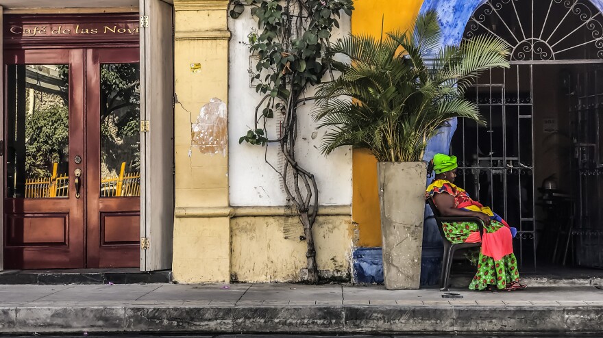 Palenquera is the word used to identify women from San Basilio de Palenque village in Colombia, which was founded by runaway African slaves in 1691. The palenquera above, wearing traditional garb, was photographed in the city of Cartagena.