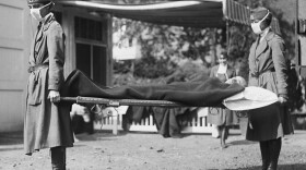 This photo made available by the Library of Congress shows a demonstration at the Red Cross Emergency Ambulance Station in Washington during the influenza pandemic of 1918.