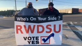Representatives from the Retail, Wholesale and Department Store Union hold a pro-unionization sign outside Amazon's warehouse in Bessemer, Ala.