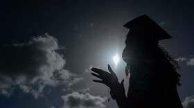 A graduating student wears a facemask during a symbolic graduation in cars to maintain social distance in Las Piedras, Puerto Rico. (Photo by Ricardo Arduengo/AFP/Getty Images) 