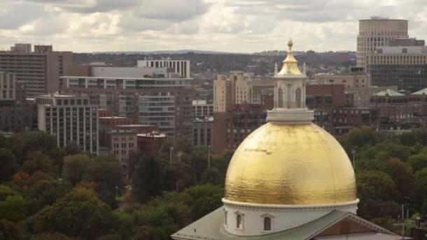 The Massachusetts State House's golden dome pictured against Boston.