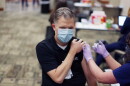 Dr. Priest poses while receiving a COVID-19 vaccine. Photo courtesy of Novant Health