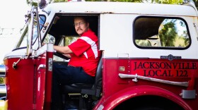 Brian Kernohan poses for a photo in his fire engine