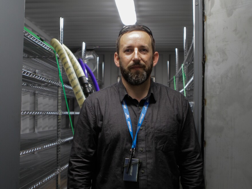 Researcher Will Richter stands inside a decontamination chamber.