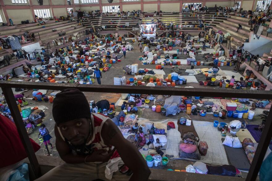 Image shows Haitians fleeing violent gang takeover of their communities taking refuge in a sports center turned shelter in Port-au-Prince in September, 2021.