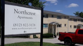 A limestone apartment complex with a sign that says Northcrest