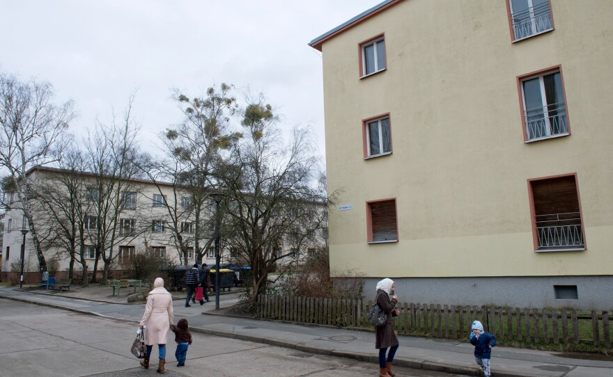 Refugees walk along on a street near the Initial Reception Camp Marienfelde in Berlin, Germany, in January. Marienfelde camp has been a transitional home for refugees in Germany for more than 60 years. But the recent influx of asylum-seekers is straining the system.