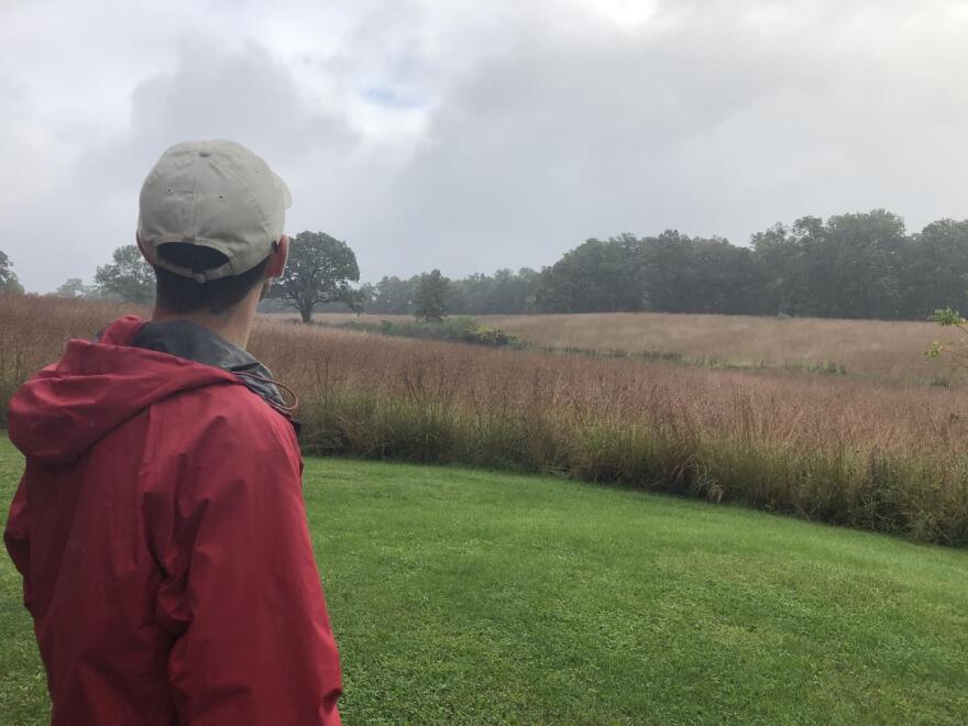 Ornithologist James Marshall sees a break in the clouds over the quiet prairie of Severson Dells Nature Center. He bird bands at the forest preserve every week during the fall migration. He says the number of birds he has banded this year is low compared 