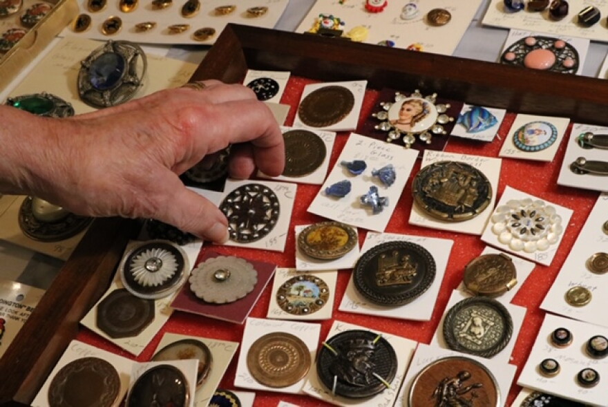 Former National Button Society President Lisa Schulz shows off some of her buttons.