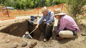 Archaeologists Rolfe Mandel, Mark Mitchell and Michele Koons inspect the excavation site dubbed 'Magic Mountain' in Golden, Colo.