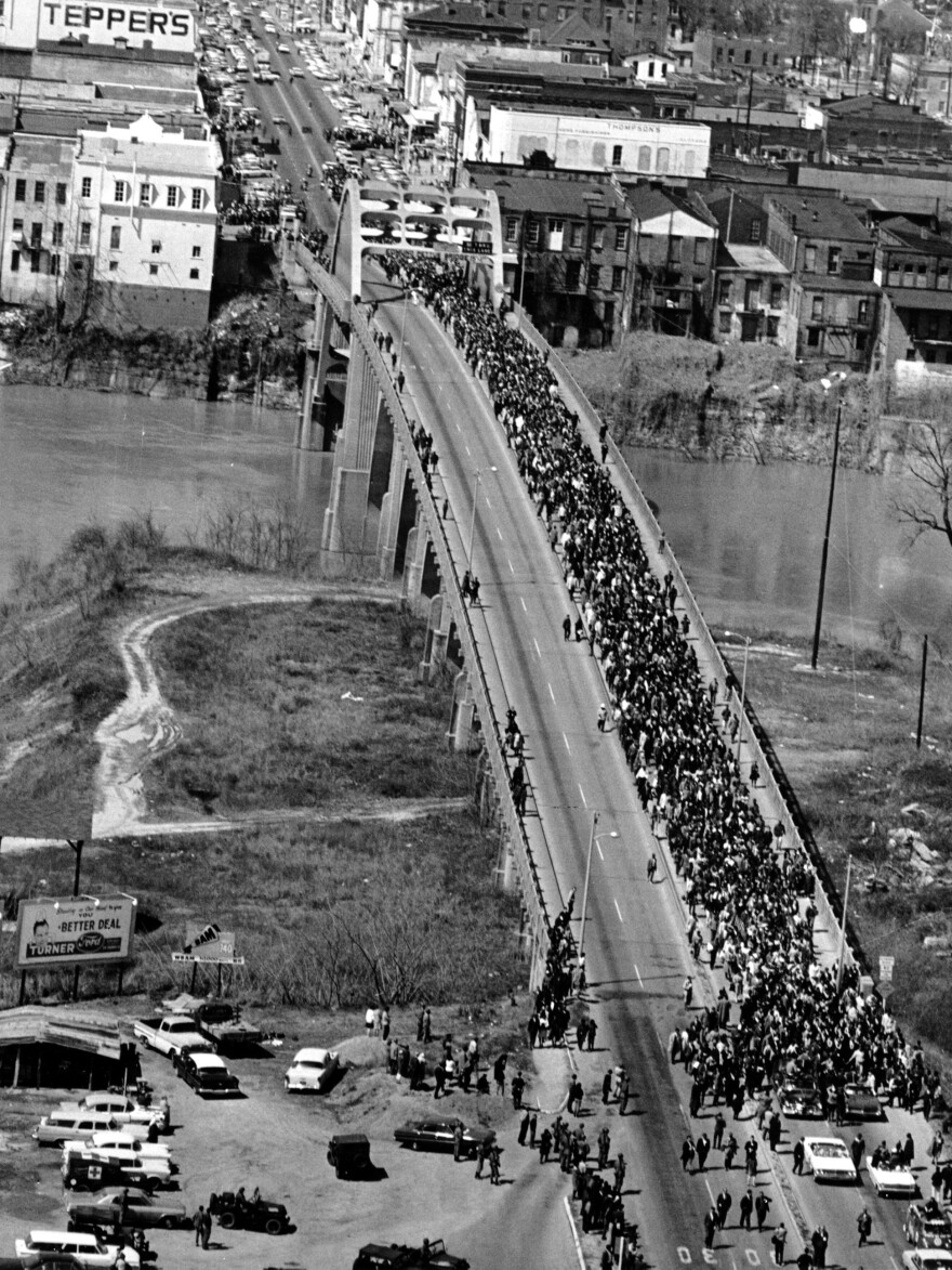 In this March 21, 1965, photo, civil rights marchers cross the Alabama River on the Edmund Pettus Bridge in Selma, Ala., toward the state capital of Montgomery.