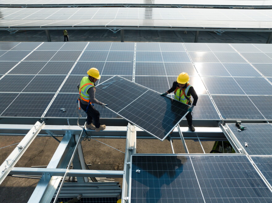 Workers are installing solar panels