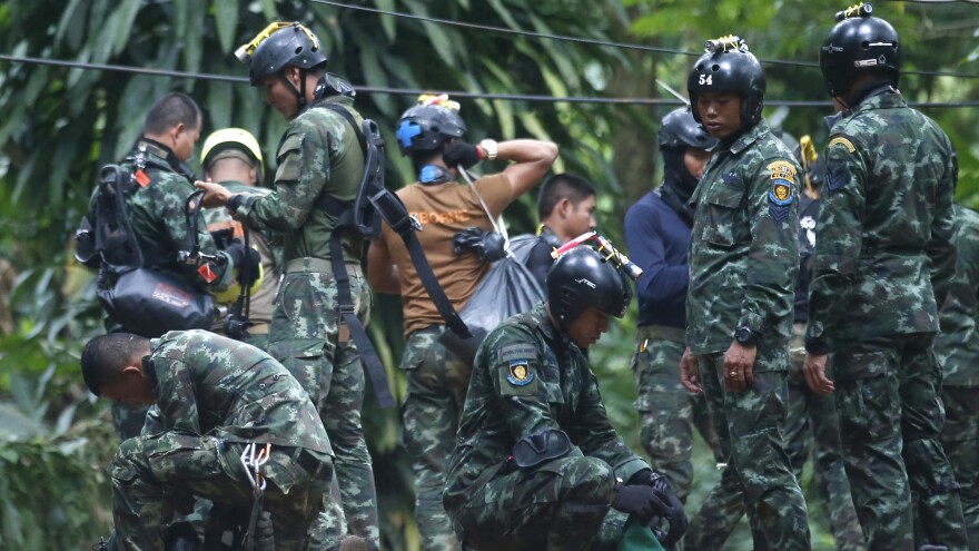 Thai rescue crews prepare Friday to enter the cave where 12 boys and their soccer coach have been trapped in Chiang Rai province, in northern Thailand. A Thai diver died while on a supply mission.
