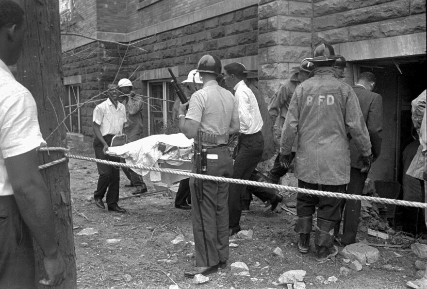 FILE - Firefighters and ambulance attendants remove a covered body from the 16th Street Baptist Church in Birmingham, Ala., Sept. 15, 1963, after a deadly explosion detonated by members of the Ku Klux Klan during services. Alabama on Friday, Sept. 15, 2023, will mark the 60th anniversary of the bombing that killed four girls. Lisa McNair, the sister of one of the victims, said as the anniversary is remembered, she hoped people will think about what they can do to combat hate. (AP Photo, File)