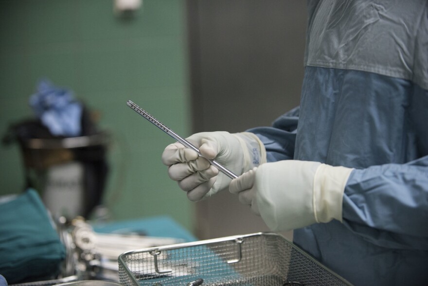 A military doctor sets up surgical tools