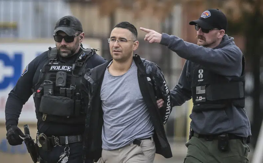 Solomon Pena, center, a Republican candidate for New Mexico House District 14, is taken into custody by Albuquerque Police officers, Monday, Jan. 16, 2023, in southwest Albuquerque, N.M. Pena was arrested in connection with a recent series of drive-by shootings targeting Democratic lawmakers in New Mexico.