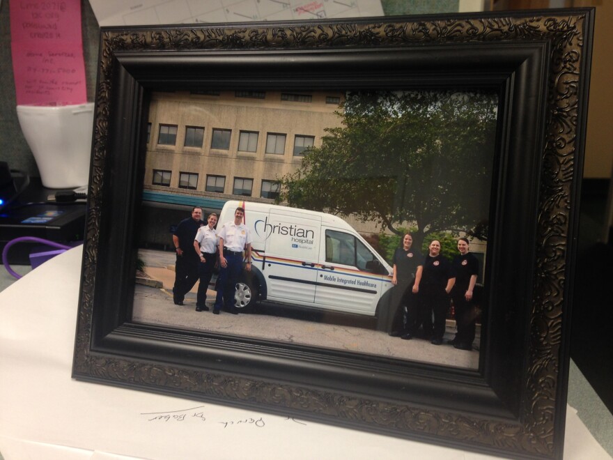 A photo of members of the mobile health team sits on a desk in the paramedics' group office at Christian Hospital. 