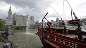 The Anthony J. Celebrezze rests near Fire Station 21 on the Cuyahoga River, Thursday, June 13, 2019, in Cleveland. Fire Station 21 battles the fires on the Cuyahoga River. The Celebrezze extinguished hot spots on a railroad bridge torched by burning fluids and debris on the Cuyahoga in 1969. (Tony Dejak/AP)