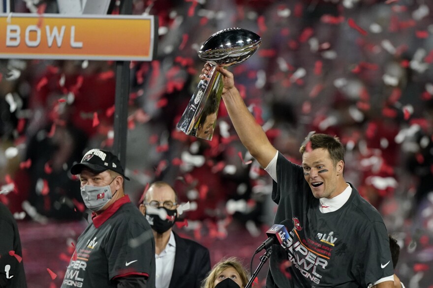 Quarterback Tom Brady celebrates with the Vince Lombardi Trophy after leading theTampa Bay Buccaneers to Super Bowl victory against the Kansas City Chiefs on Sunday.