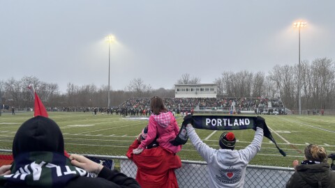 Hearts of Pine fans hold up scarves as they await kickoff of the teams first ever game.