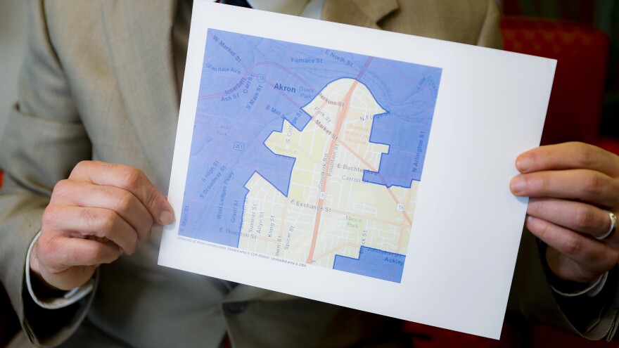 David Niven, a professor of political science at the University of Cincinnati, holds a map depicting a gerrymandered Ohio district.