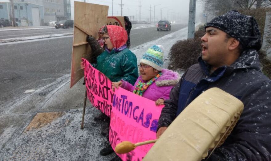 Matthew Carlson, 35, beats a drum and sings Tlingit songs in protest on Jan. 22, 2018 on Egan Drive in Juneau. Carlson, who lives in Juneau but is originally from Angoon, was protesting the City and Borough of Juneau’s plans to annex parts of Admiralty Island. (Photo by Jacob Resneck/KTOO)