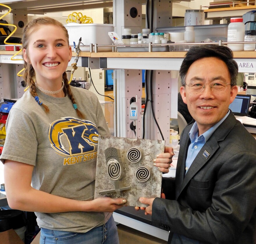 photo of Angela Deibel and Dr. Yanhai Du holding one type of fuel cell.