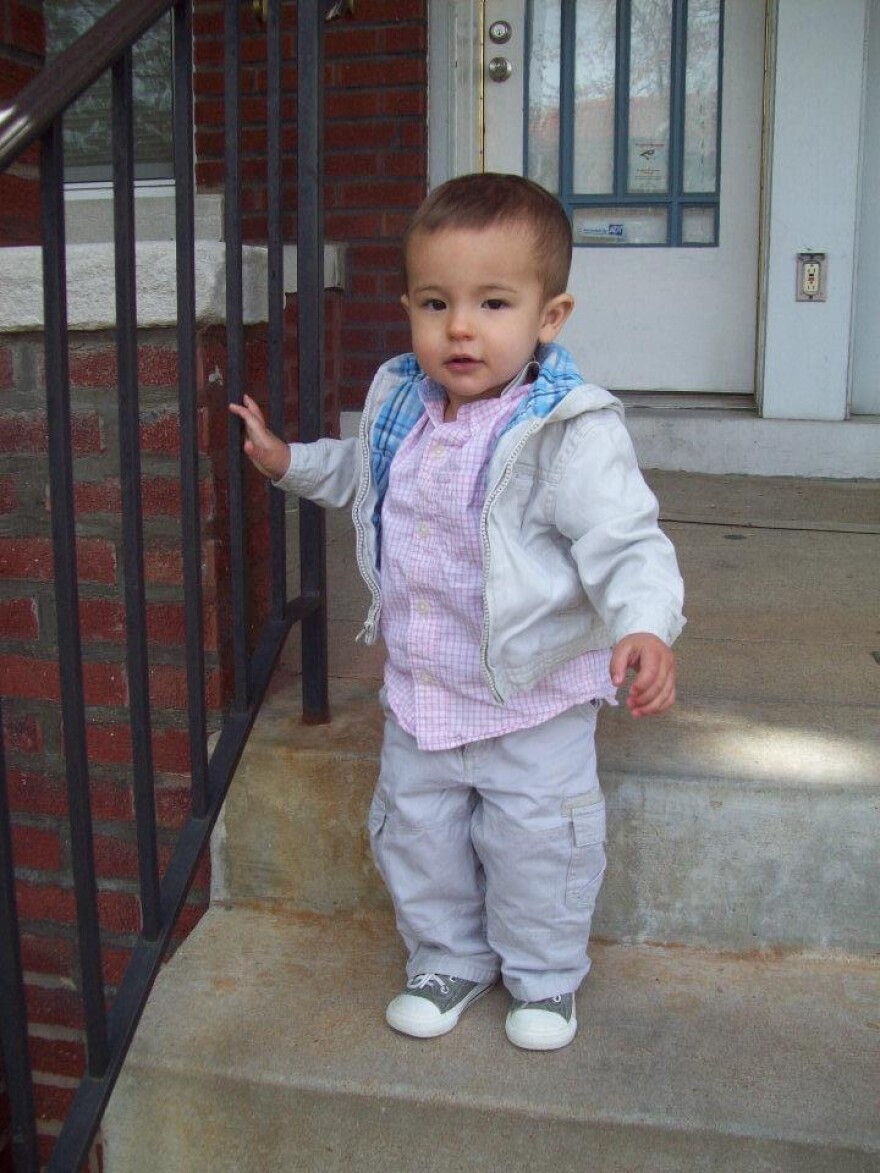 Lisa Pascoe's son on the steps in front of the St. Louis County home where he was lead poisoned in 2012.