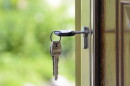 Real estate house key in door hero