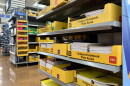 An end cap of an aisle at Walmart holds yellow boxes of notebooks. 