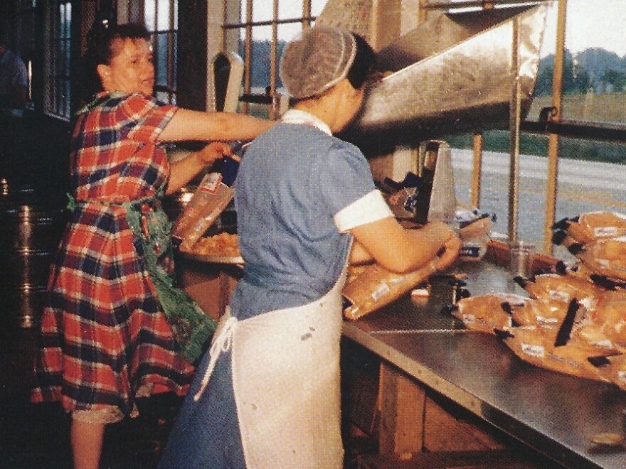 Mim Herr (right), with Mary Wowrer, packing chips by hand.