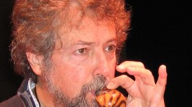 Musician playing a small gourd.
