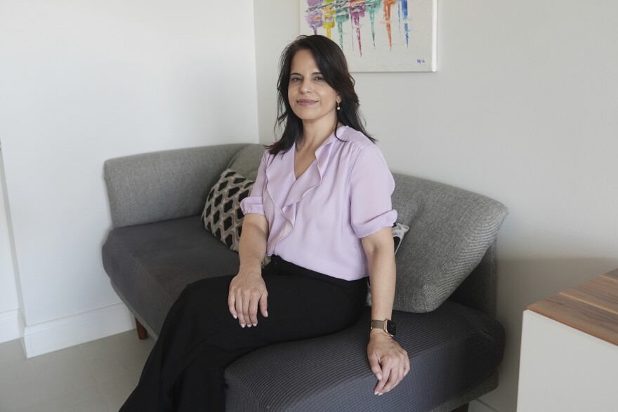 Real estate agent Rebeca Castellon, sits in her condominium Monday, Nov. 25, 2024, in Coral Gables, Fla. Castellon agrees with the idea of requiring condo associations to maintain reserves for future repairs but acknowledges that the timing is bad when the increased fees are combined with higher insurance costs and recent inflation.