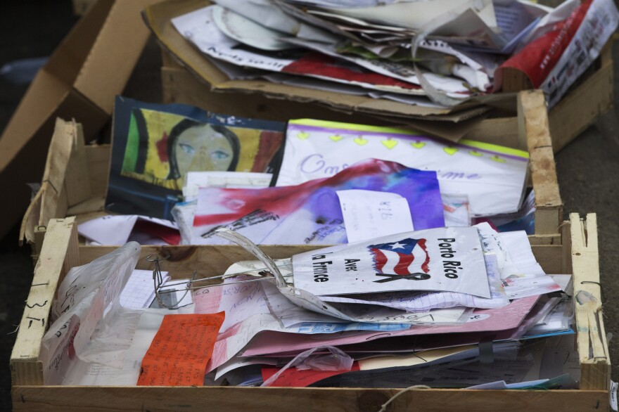 Objects collected by city agents from the memorial at the Bataclan lie in baskets outside the concert hall in Paris on December 10.