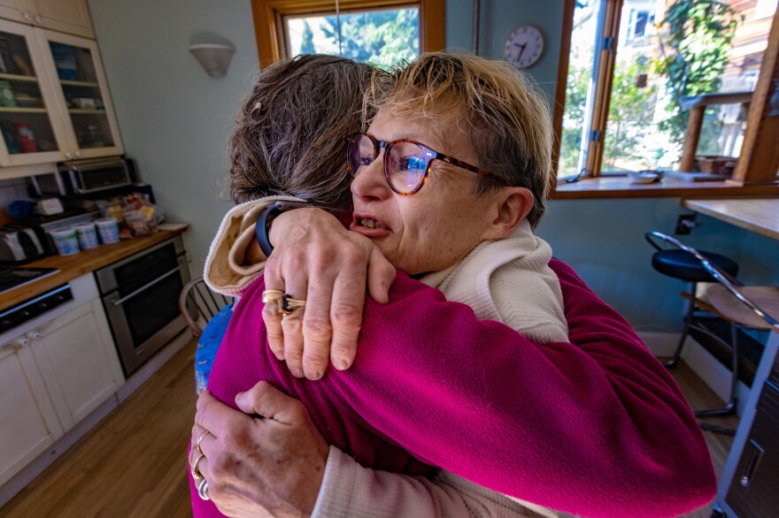 An elated Diane Pullen thanks Dawn Drevers for completing the sweater.