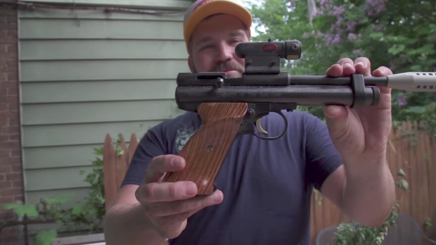 Matt Fouse, also known as the Rat Czar, shows off his collection of weapons that he uses to hunt for rats in his Baltimore backyard.