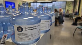 Emergency water jugs lined up on a table
