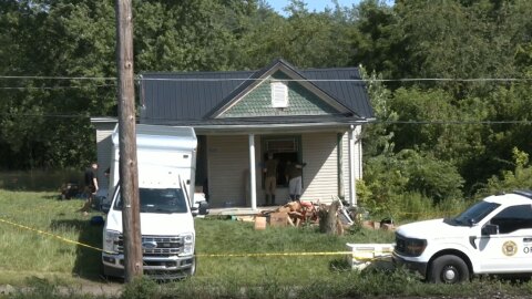 Investigators look through after 16 children were removed from a small house.