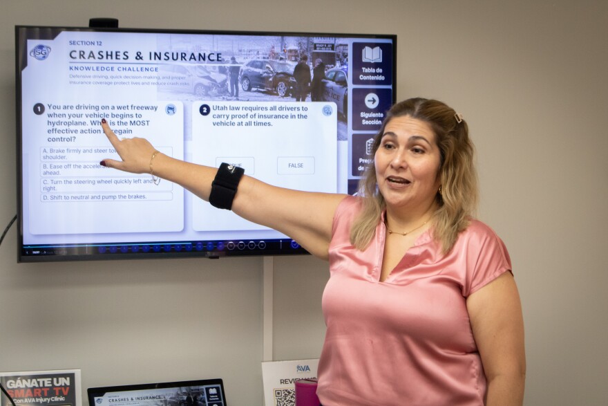 Carolina Gaitan teaches a group of Spanish speakers in a class in Ogden to pass the English driving test, Aug. 4, 2026.